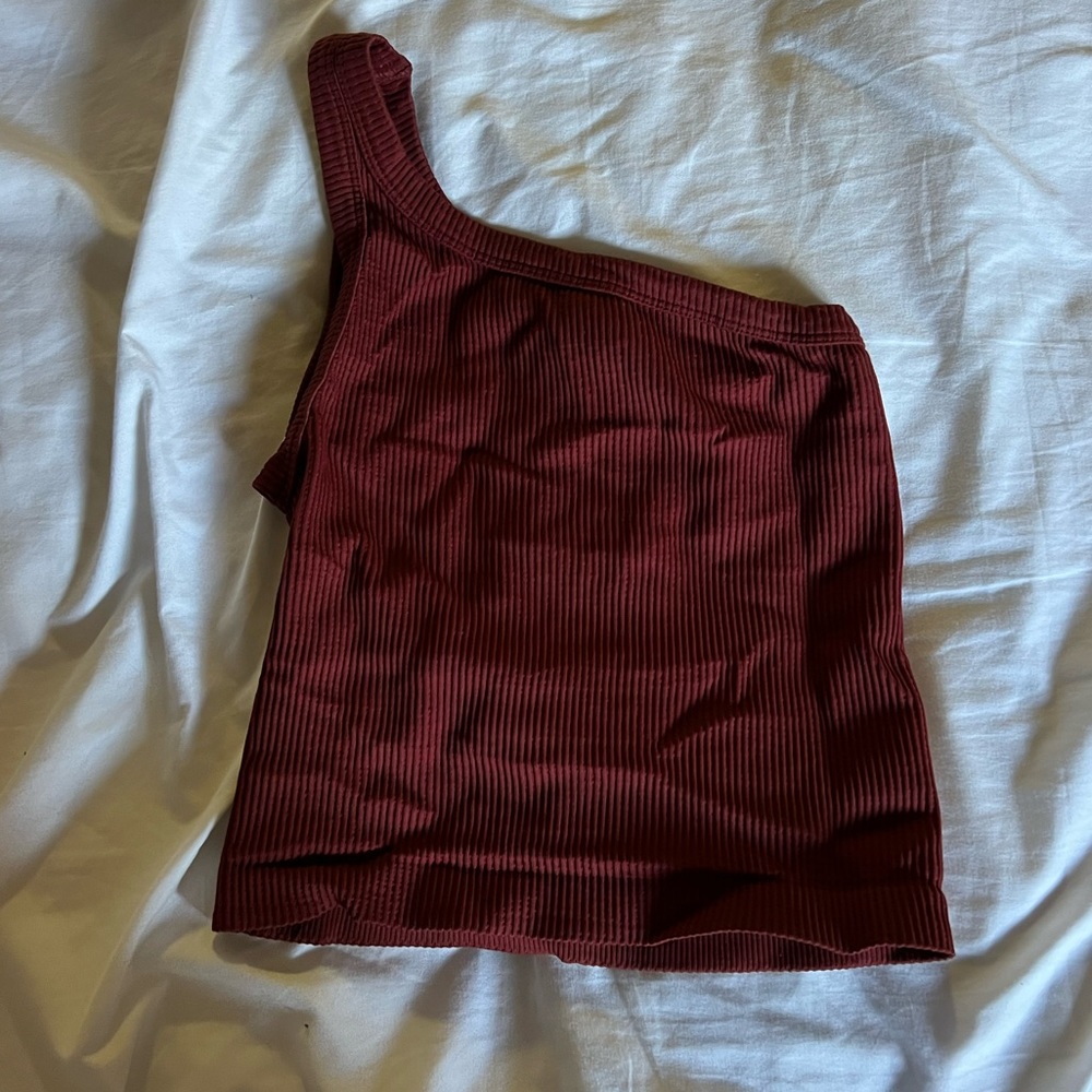 One shoulder top in a red/brown color